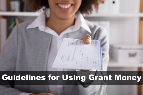 grant money guidelines - woman handing over check